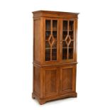 Beech cabinet bookcase, the upper section fitted three shelves enclosed by a pair of glazed doors,