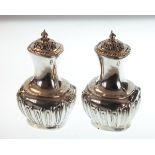 Pair of Victorian baluster shaped pepperettes, each having fluted decoration, Birmingham 1899, 3.5oz