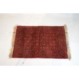 Middle Eastern wool rug having geometric decoration on a red ground within multi borders Condition: