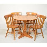 Varnished pine circular drop-leaf kitchen table and four chairs Condition: