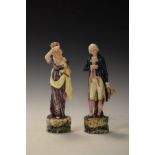 Pair of Continental polychrome decorated pottery figures formed as a gallant and lady Condition: