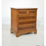 Reproduction walnut finish chest of two short over three long drawers, together with a