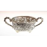 Chinese export silver salt having pierced dragon decoration, bamboo formed handles and a clear glass