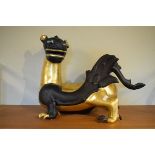 Modern ceramic figure of an oriental dragon decorated in black with gilt highlights Condition: