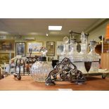 Early 20th Century silver plated six bottle cruet set, silver plated toast rack and an alpaca