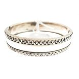 White metal snap bangle having two bands of applied filigree decoration Condition: