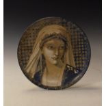 Late 19th Century pottery charger having hand painted decoration depicting the head of a maiden