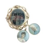 Gilt metal oval mourning brooch, the front panel housing a family photograph, the reverse with