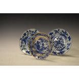 Pair of Japanese porcelain plates having blue and white painted decoration together with another