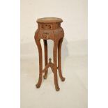 Eastern carved octagonal top plantstand standing on four splayed supports united by a cross