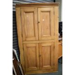 Stripped pine floor standing corner cupboard fitted four panelled doors Condition: