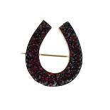 Gold coloured metal horseshoe shape garnet set brooch Condition: