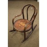 Early 20th Century child's Bentwood rocking chair, the seat decorated with a Dutch girl amongst