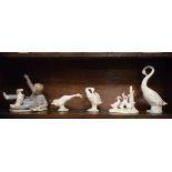 Two Lladro figures of geese, two similar Nao figures and a Nao figure group depicting a boy with a