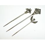 Three early 20th Century Continental silver plated meat skewers, each having a decorative finial