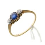 Dress ring set two diamonds flanking a sapphire coloured stone, the shank stamped 18ct, size P