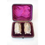 Pair of Victorian silver pepperettes of cylindrical form, each having fluted decoration and standing
