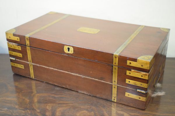 19th Century brass bound mahogany writing box, the double hinged cover opening to reveal a partially