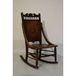 Late 19th Century beech framed rocking chair having carved crest and spindle turned frieze with a