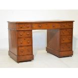 Late Victorian oak double pedestal knee hole desk having an inset leather writing surface and fitted