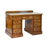 Late 19th/early 20th Century figured walnut double pedestal kneehole desk having an inset leather