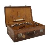 Late 19th/early 20th Century leather suitcase, opening to reveal a fitted interior with eleven glass