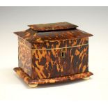 19th Century tortoiseshell sarcophagus shaped tea caddy, the hinged cover opening to reveal a lift-