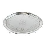 George III engraved silver teapot stand of elliptical form, standing on four ball and claw feet,