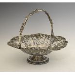 Victorian silver cake basket having pierced and embossed fruit decoration, swing handle and standing