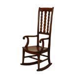 Late 19th Century mahogany rocking chair having a high triple wavy lath back, open scroll arms, hard