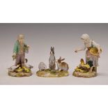 Pair of late 19th/early 20th Century Meissen figures depicting a young boy and girl, he feeding