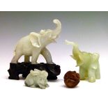 Two green hardstone figures of elephants, 7.5cm and 8.5cm high, a similar figure of a hare ,2.75cm