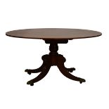 Regency satinwood crossbanded mahogany oval snap top breakfast table standing on a turned pillar and