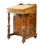 Victorian figured walnut Davenport, the hinged cover opening to reveal a partially fitted