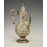 George III silver baluster shaped coffee pot having later embossed decoration, domed cover and