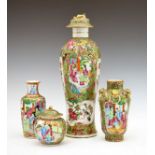 Four Cantonese Famille Rose vases, each typically decorated with alternate reserves depicting