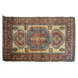 Modern Middle Eastern rug decorated with a central medallion on a light brown ground within multi