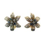 Pair of sapphire and diamond flowerhead ear clips, unmarked, set to the centre of each ear clip a