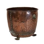 Early 20th Century riveted copper log bin having lion mask ring drop handles and standing on three