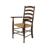 Early 20th Century Cotswold style ladder back open arm elbow chair having a rush seat and standing