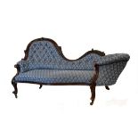Victorian carved walnut framed drawing room sofa having low and high ends and standing on carved