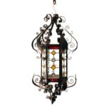 Wrought iron framed ceiling lantern, the hexagonal centre section having stained and leaded glass