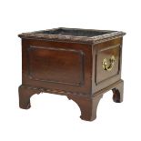 Mahogany square shaped coal/log bin having a carved rim, brass handles and standing on bracket feet,