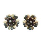 Pair of diamond and ruby set flower head ear clips, unmarked, with a cluster centre and a collet set