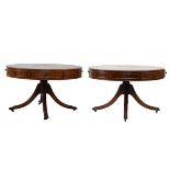 Matched pair of reproduction mahogany low drum tables, each having an inset leather top, fitted real