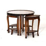 Nest of four figured walnut finish and beech coffee tables Condition: