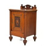 Edwardian oak pot cupboard having a carved panelled door and standing on reeded supports Condition: