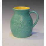 1930's period Bretby ovoid jug having incised foliate decoration on a green ground and with yellow