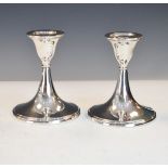 Pair of George V silver candlesticks, each standing on a flared circular base, Birmingham 1918,