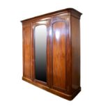 Victorian mahogany three door wardrobe, two doors enclosing a fitted interior with four slides and
